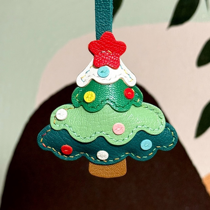 Colorful Christmas tree leather bag charm featuring festive details...